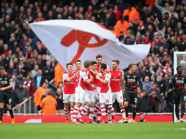 Hector Bellerin of Arsenal celebrates with team-mates after scoring the opening goal during the Barclays Premier League match between Arsenal and Liverpool at Emirates Stadium on April 4, 2015