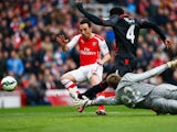  Santi Cazorla of Arsenal sees the ball cleared by Kolo Toure and Simon Mignolet of Liverpool during the Barclays Premier League match between Arsenal and Liverpool at Emirates Stadium on April 4, 2015