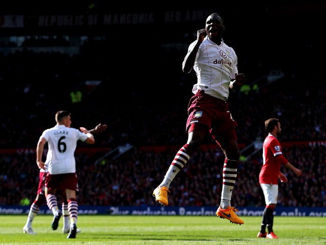 Christian Benteke of Aston Villa celebrates after scoring his team's first goal during the Barclays Premier League match between Manchester United and Aston Villa at Old Trafford on April 4, 2015