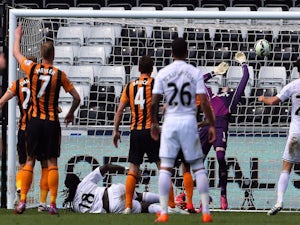 Swansea City's French striker Bafetimbi Gomis (3rd L) scores their second goal past Hull City's Scottish goalkeeper Allan McGregor (2nd R) during the English Premier League football match between Swansea City and Hull City at The Liberty Stadium in Swanse