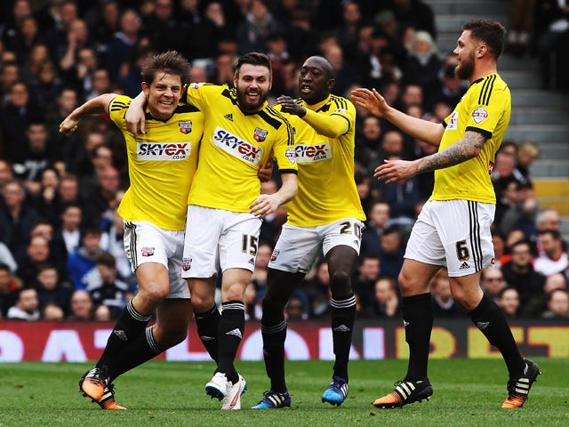 Stuart Dallas of Brentford celebates with team mates after opening the scoring during the Sky Bet Championship match between Fulham and Brentford at Craven Cottage on April 3, 2015