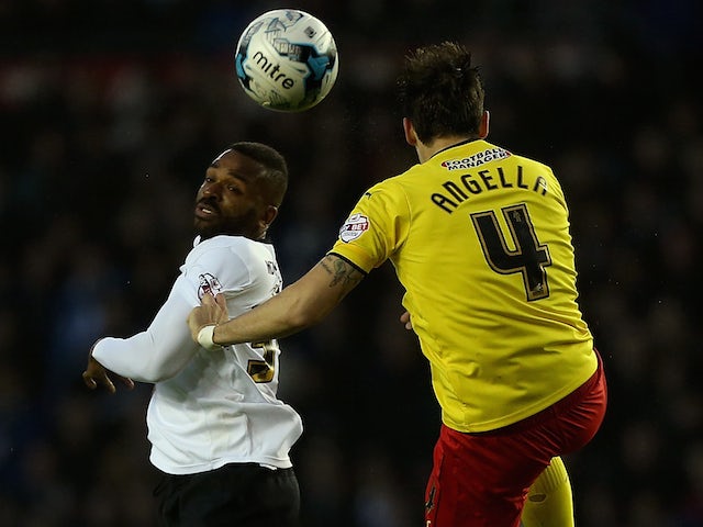Darren Bent of Derby and Gabriele Angella of Watford battle for an aerial ball during the Sky Bet Championship match between Derby County and Watford at iPro Stadium on April 3, 2015