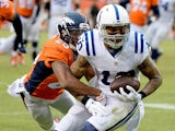 Donte Moncrief #10 of the Indianapolis Colts is tackled by Chris Harris #25 of the Denver Broncos during a 2015 AFC Divisional Playoff game at Sports Authority Field at Mile High on January 11, 2015