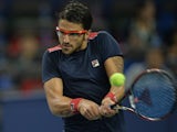Janko Tipsarevic of Serbia hits a return to Marcel Granollers of Spain in their first round match of the Shanghai Masters tennis tournament in Shanghai on October 7, 2013