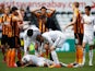 Referee Andre Marriner checks on Kyle Naughton of Swansea City after showing the red card to David Meyler of Hull City during the Barclays Premier League match between Swansea City and Hull City at Liberty Stadium on April 4, 2015
