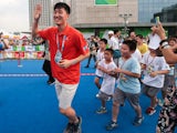 Olympic 110m hurdle champion Liu Xiang interacts with children during the IAAF Kids Athletics Program at Wanda Plaza on August 20, 2014