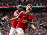 Ander Herrera of Manchester United celebrates with team-mate Ashley Young of Manchester United after scoring the opening goal during the Barclays Premier League match between Manchester United and Aston Villa at Old Trafford on April 4, 2015