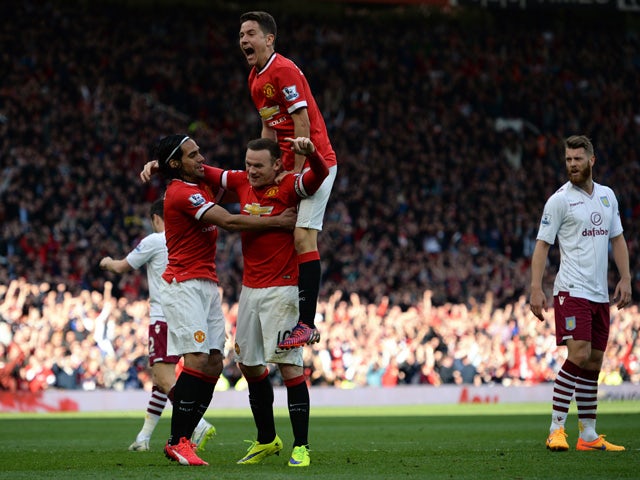 Manchester United's English striker Wayne Rooney celebrates after he scores their second goal during the English Premier League football match between Manchester United and Aston Villa at Old Trafford in Manchester, North West England on April 4, 2015