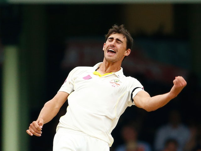 Mitchel Starc of Australia celebrates after taking the wicket of Suresh Raina of India during day five of the Fourth Test match between Australia and India at Sydney Cricket Ground on January 10, 2015