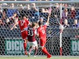 Juan Agudelo #17 of New England Revolution puts the ball in the back of the net for a goal in the 18th minute against Jared Watts #33 of Colorado Rapids as Charlie Davies #9 of New England Revolution celebrates to take a 1-0 lead against the Colorado Rapi