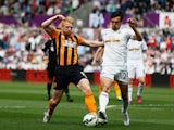 Paul McShane of Hull City is challenged by Jack Cork of Swansea City during the Barclays Premier League match between Swansea City and Hull City at Liberty Stadium on April 4, 2015