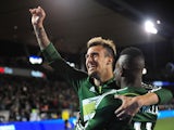 Maximiliano Urruti #37 of Portland Timbers celebrates with teammate Dairon Asprilla #11 of Portland Timbers after scoring a goal during the second half of the game against the FC Dallas at Providence Park on April 4, 2015