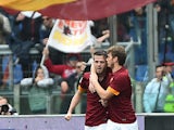 Roma's midfielder from Bosnia-Herzegovina Miralem Pjanic is congratulated by teammate Roma's forward from Serbia Adem Ljajic after scoring during the Italian Serie A football match between AS Roma and Napoli on April 04, 2015