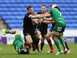 Tim Visser of Edinburgh is tackled by Eamonn Sheridan (L) and Blair Cowan of London Irish during the European Rugby Challenge Cup Quarter Final between London Irish and Edinburgh Rugby at Madejski Stadium on April 5, 2015