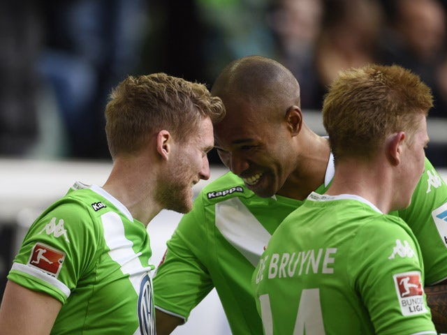 Wolfsburg's striker Andre Schurrle celebrates with his team-mates after scoring his first goal for his new side during the German first division Bundesliga football match VfL Wolfsburg vs VfB Stuttgart in Wolfsburg, northern Germany, on April 4, 2015