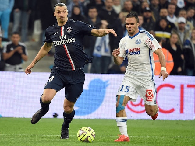 Paris Saint-Germain's Swedish midfielder Zlatan Ibrahimovic (L) vies with Marseille's French defender Jeremy Morel during the French L1 football match between Marseille (OM) and Paris (PSG) on April 5, 2015