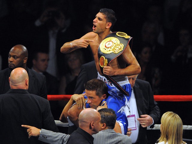 British boxer Amir Khan celebrates after defeating Northern Ireland's Paul McCloskey following their WBA Super Lightweight World Championship boxing fight at the MEN arena in Manchester, north-west England on April 16 2011