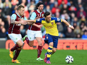 Mesut Ozil of Arsenal holds off Scott Arfield of Burnley during the Barclays Premier League match between Burnley and Arsenal at Turf Moor on April 11, 2015