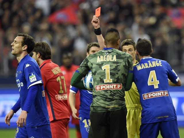 French referee Benoît Bastien gives a red card to Bastia's French defender Sebastien Squillaci during the French League Cup final football match Bastia (SCB) vs Paris Saint-Germain, on April 11, 2015
