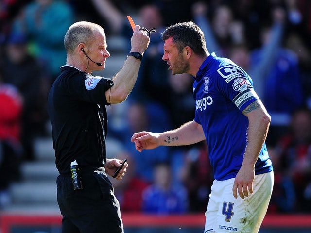 Referee, Andy Woolmer shows a red card to Paul Robinson of Birmingham City during the Sky Bet Championship match between AFC Bournemouth and Birmingham City at Goldsands Stadium on April 6, 2015