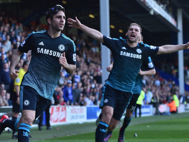 Chelsea's Spanish midfielder Cesc Fabregas celebrates with Chelsea's Serbian defender Branislav Ivanovic after scoring their goal during the English Premier League football match between Queens Park Rangers and Chelsea at Loftus Road Stadium in London on 