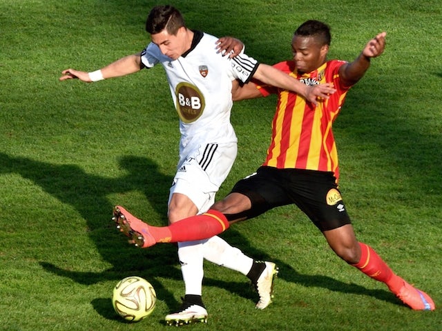 Lorient's French forward Giani Bruno (L) vies with Lens' French midfielder Wylan Cyprien during the French football match between Lens and Lorient on April 12, 2015