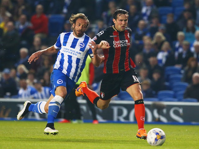 Inigo Calderon of Brighton & Hove Albion and Charlie Daniels of Bournemouth chase the ball during the Sky Bet Championship match on April 10, 2015