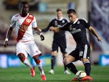 James Rodriguez (R) of Real Madrid CF competes for the ball with Mohammed Fatau (L) of Rayo Vallecano de Madrid during the La Liga match between Rayo Vallecano de Madrid and Real Madrid CF at Vallecas Stadium on April 8, 2015