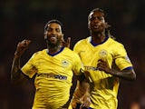 Jermaine Pennant of Wigan Athletic (L) celebrates with Gaetan Bong as he scores their first and equalising goal from a free kick during the Sky Bet Championship match between Fulham and Wigan Athletic at Craven Cottage on April 10, 2015