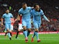 Sergio Aguero of Manchester City celebrates with David Silva as he scores their first goal during the Barclays Premier League match between Manchester United and Manchester City at Old Trafford on April 12, 2015