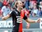 Rennes' forward Ola Toivonen (R) celebrates after scoring during the French L1 football match between Rennes and Guingamp on April 12, 2015