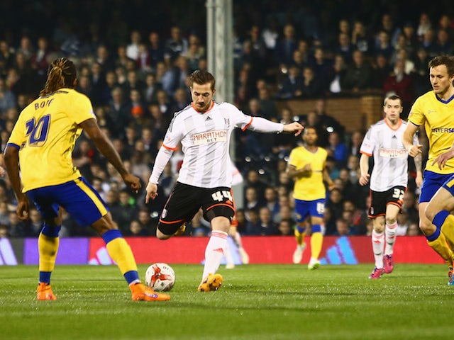 Ross McCormack of Fulham shoots past the Wigan Athletic defence to score their first goal during the Sky Bet Championship match between Fulham and Wigan Athletic at Craven Cottage on April 10, 2015