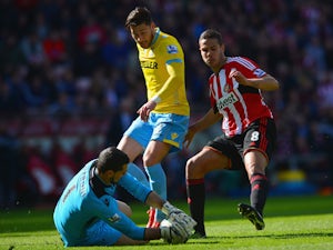Julian Speroni of Crystal Palace makes the ball safe against Jack Rodwell of Sunderland during the Barclays Premier League match between Sunderland and Crystal Palace at Stadium of Light on April 11, 2015 