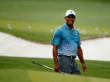 Tiger Woods of the United States smiles on the practice range during a practice round prior to the start of the 2015 Masters Tournament at Augusta National Golf Club on April 6, 2015