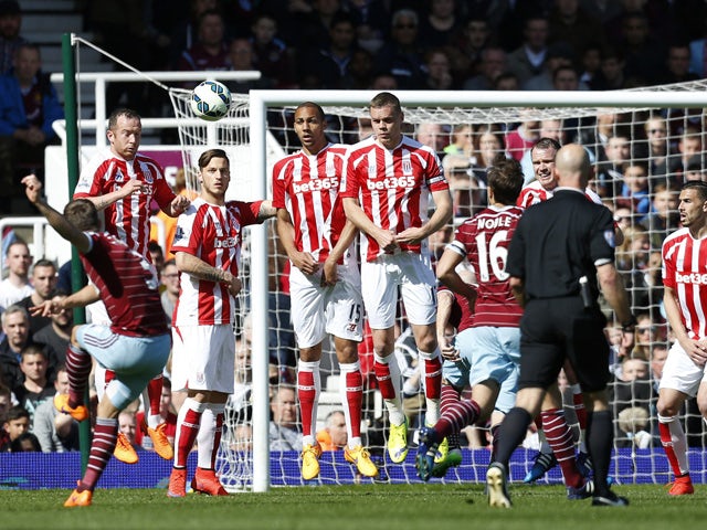 West Ham United's English defender Aaron Cresswell scores from this free kick during the English Premier League football match between West Ham United and Stoke City at Upton Park in London on April 11, 2015