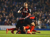 Yann Kermorgant of Bournemouth (obscured) is mobbed by team mates in celebration as he scores their first goal from a free kick during the Sky Bet Championship match between Brighton & Hove Albion and AFC Bournemouth at Amex Stadium on April 10, 2015