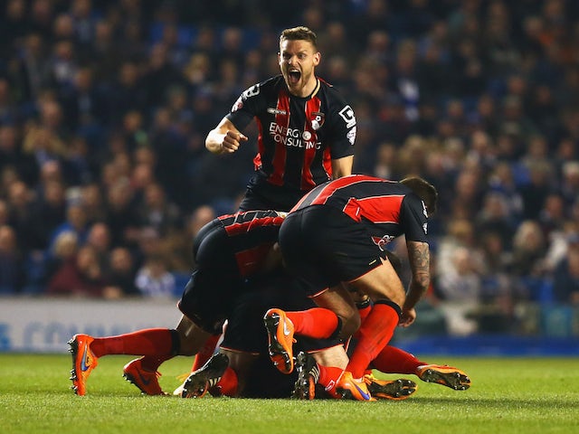 Yann Kermorgant of Bournemouth (obscured) is mobbed by team mates in celebration as he scores their first goal from a free kick during the Sky Bet Championship match between Brighton & Hove Albion and AFC Bournemouth at Amex Stadium on April 10, 2015