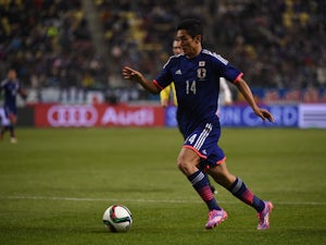 Yoshinori Muto of Japan dribbles the ball during the international friendly match between Japan and Tunisia at Oita Bank Dome on March 27, 2015