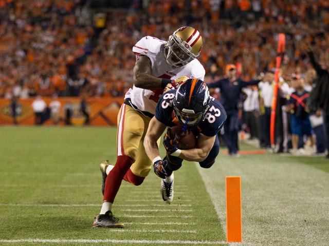 Wide receiver Wes Welker #83 of the Denver Broncos is forced out of bounds at the goal line by strong safety Antoine Bethea #41 of the San Francisco 49ers on a 39 yard touchdown catch at Sports Authority Field at Mile High on October 19, 2014