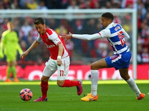 Mesut Ozil of Arsenal is marshalled by Michael Hector of Reading during the FA Cup Semi Final between Arsenal and Reading at Wembley Stadium on April 18, 2015 