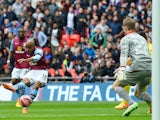 Aston Villa's English midfielder Fabian Delph shoots and scores past Liverpool's Belgian goalkeeper Simon Mignolet during the FA Cup semi-final between Aston Villa and Liverpool at Wembley stadium in London on April 19, 2015