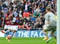 Aston Villa's English midfielder Fabian Delph shoots and scores past Liverpool's Belgian goalkeeper Simon Mignolet during the FA Cup semi-final between Aston Villa and Liverpool at Wembley stadium in London on April 19, 2015