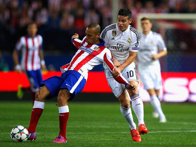 Miranda of Atletico Madrid and James Rodriguez of Real Madrid CF battle for the ball during the UEFA Champions League Quarter Final First Leg match between Club Atletico de Madrid and Real Madrid CF at Vicente Calderon Stadium on April 14, 2015