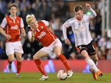 Ben Pringle of Rotherham United battles with Ryan Tunnicliffe of Fulham during the Sky Bet Championship match between Fulham and Rotherham United at Craven Cottage on April 15, 2015