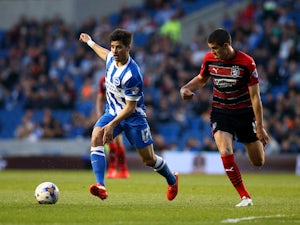 Brighton's Joao Teixeira looks to attack past Conor Coady of Huddersfield during the Sky Bet Championship match between Brighton & Hove Albion and Huddersfield Town at The Amex Stadium on April 14, 2015