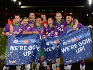 An assortment of Bristol City players celebrate their promotion to the Championship on April 14, 2015