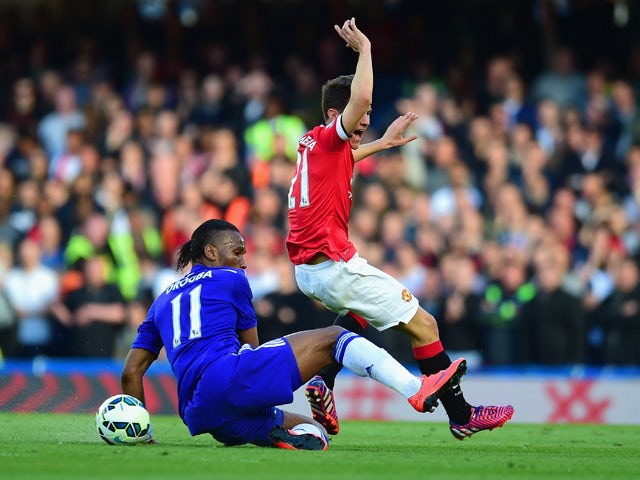 Didier Drogba of Chelsea tackles Ander Herrera of Manchester United during the Barclays Premier League match between Chelsea and Manchester United at Stamford Bridge on April 18, 2015