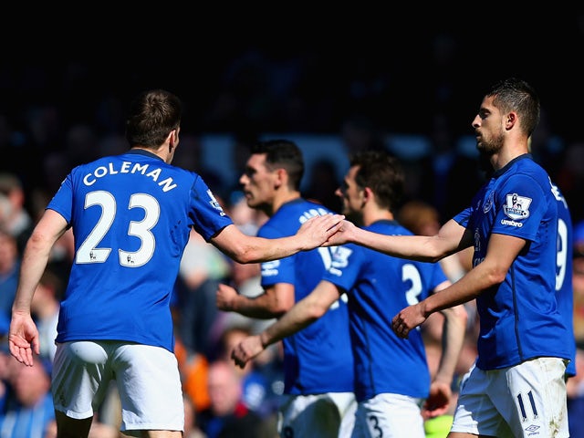 Seamus Coleman of Everton congratulates Kevin Mirallas of Everton on scoring the opening goal during the Barclays Premier League match between Everton and Burnley at Goodison Park on April 18, 2015