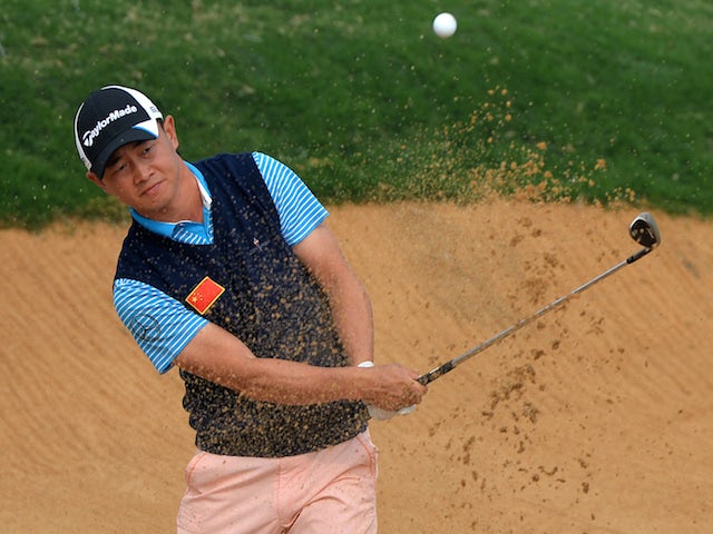 Huang Wen Yi of China plays from the bunker on the 7th hole during day one of the BMW Shanghai Masters golf tournament at the Lake Malaren Golf Club in Shanghai on October 24, 2013