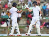 Ian Bell and Joe Root of England bring up their 150 run partnership during day one of the 1st Test match between West Indies and England at the Sir Vivian Richards Stadium on April 13, 2015